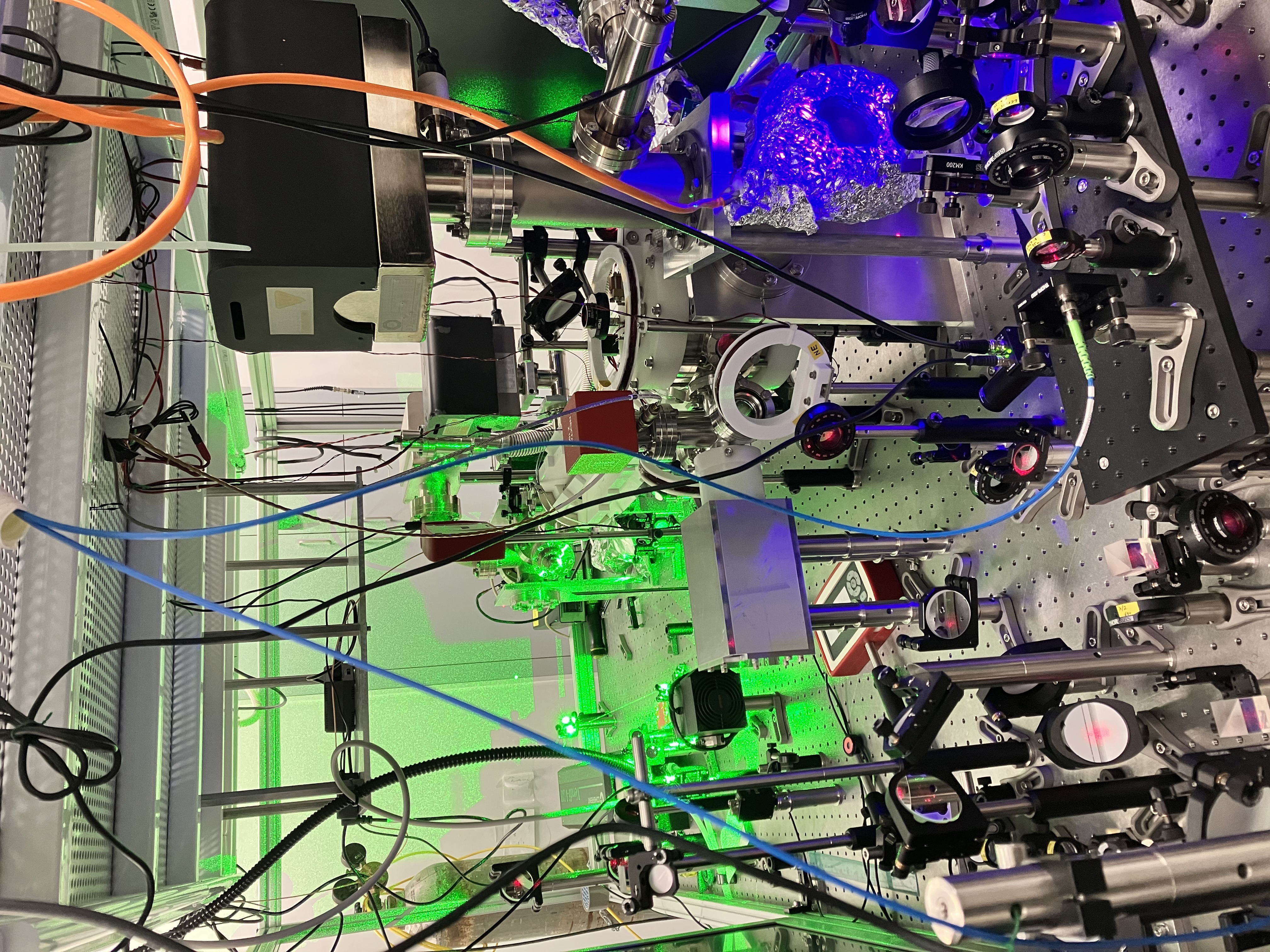 Laser optics table with green and blue laser beams